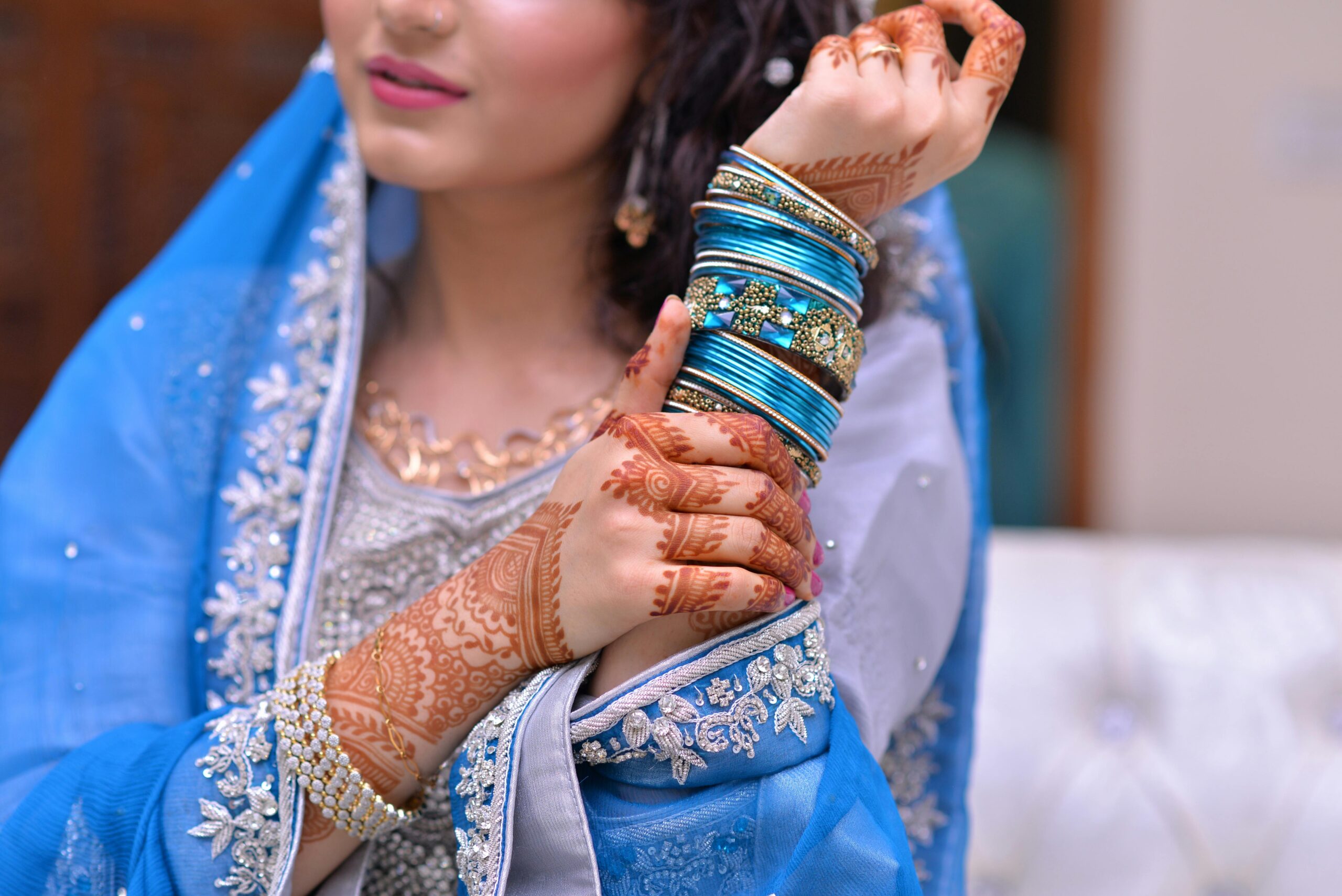 pexels photo 1297483 1297483 A bride showcases intricate henna designs and vibrant jewelry in traditional attire.